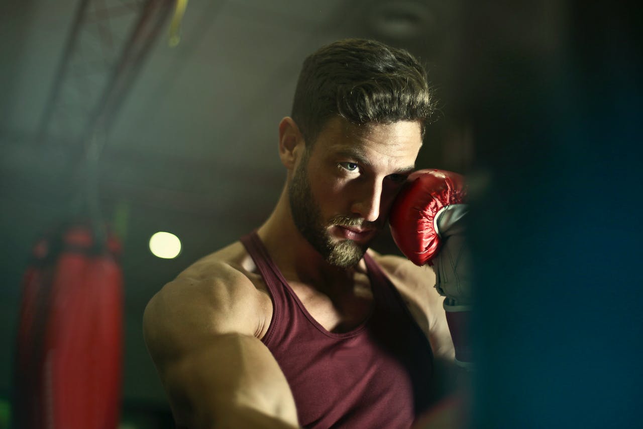 Gym clothes for men - guy working out in a red stringer tank top